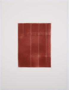Red surface with creases in a linear fashion.