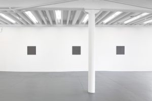 Gallery view of three works on a single wall.