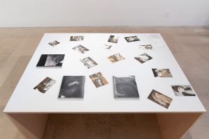 Table top with images and books scattered across.