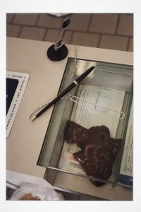 Photograph of a liver at a bank deposit slip counter.