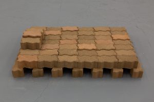 Low stack of bricks with zig-zag sides.