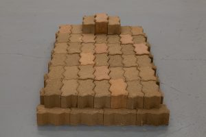 Low stack of bricks with zig-zag sides.
