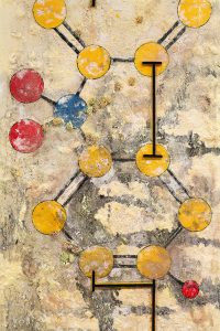 Closeup showing geometric structures and metal rods connecting them in the painting.