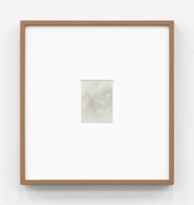 A small piece of foil in a frame that reflects different colors of light from different viewing positions.
