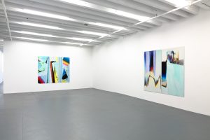 Gallery view of two multicolor abstract works on the walls