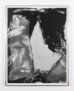 Black and white photograph with collage-like abstract composition of bones and dark areas left improperly exposed