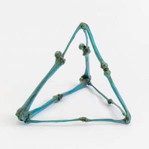 Bronze pyramidal sculpture made with green patina bones affixed to each other