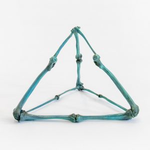 Bronze pyramidal sculpture made with green patina bones affixed to each other
