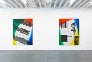 Two paintings with blue, yellow, green, and red with black marks on a white surface