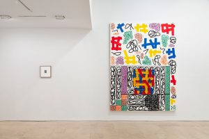 Gallery view from left to right: small framed work and large colorful painting