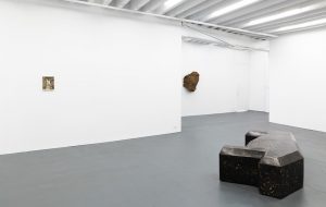 Gallery view of two sculptures and a painting.