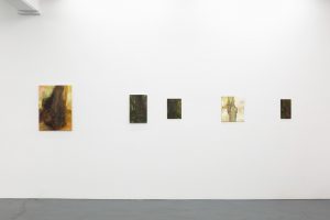 Gallery view of five artworks arranged on a wall.