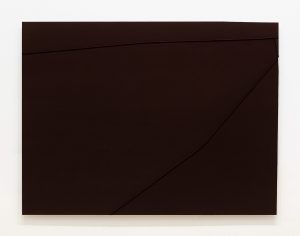 Solid brown sheet of metal with ridges near the top and right side.