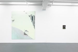 Gallery view of large green painting on the left, and a small painting of a hand on the right.
