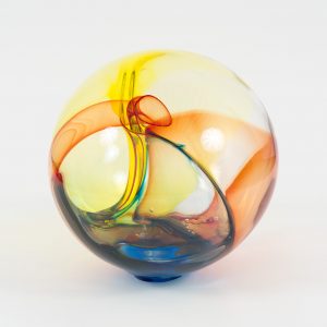 Glass sphere composed of blue, red, and yellow, featuring a knot inside of itself.